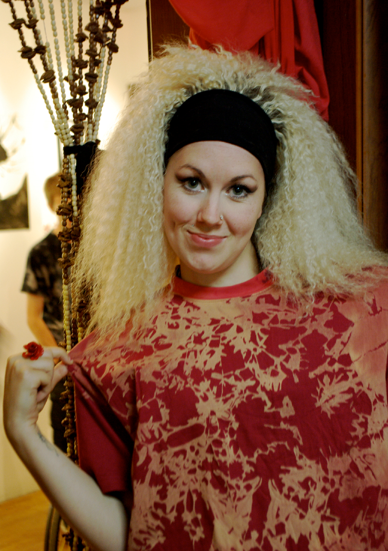 Red shirt worn to show its dense all-over bleach-painted floral pattern