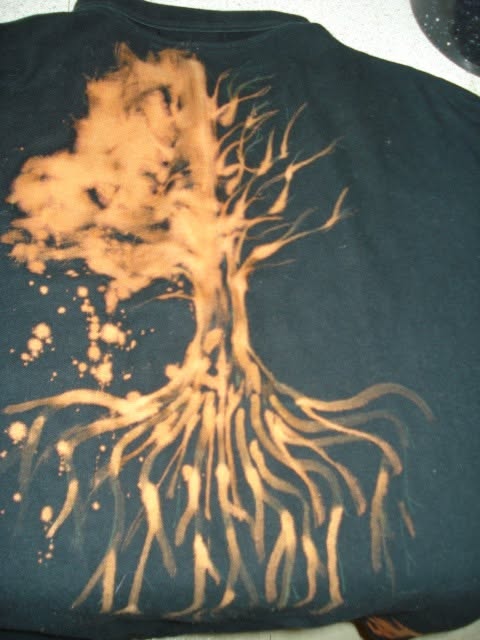 Bleach-painted tree with exposed roots spreading across a dark shirt