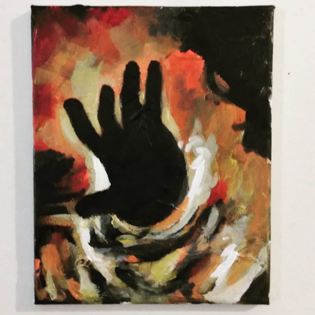 Painting of a dark hand silhouette held against rising flames