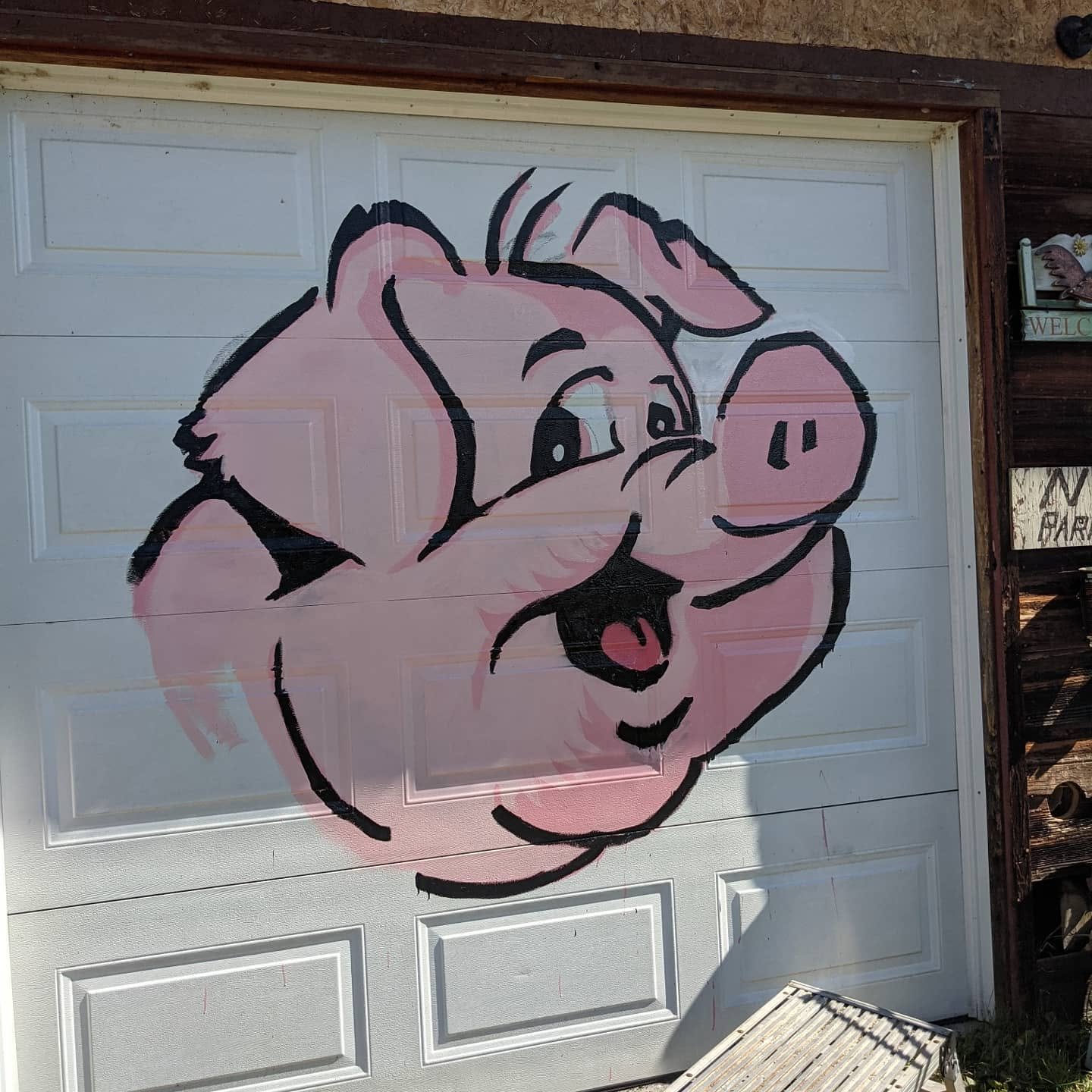 Finished Hog Saloon pig mural showing the pink character and black linework