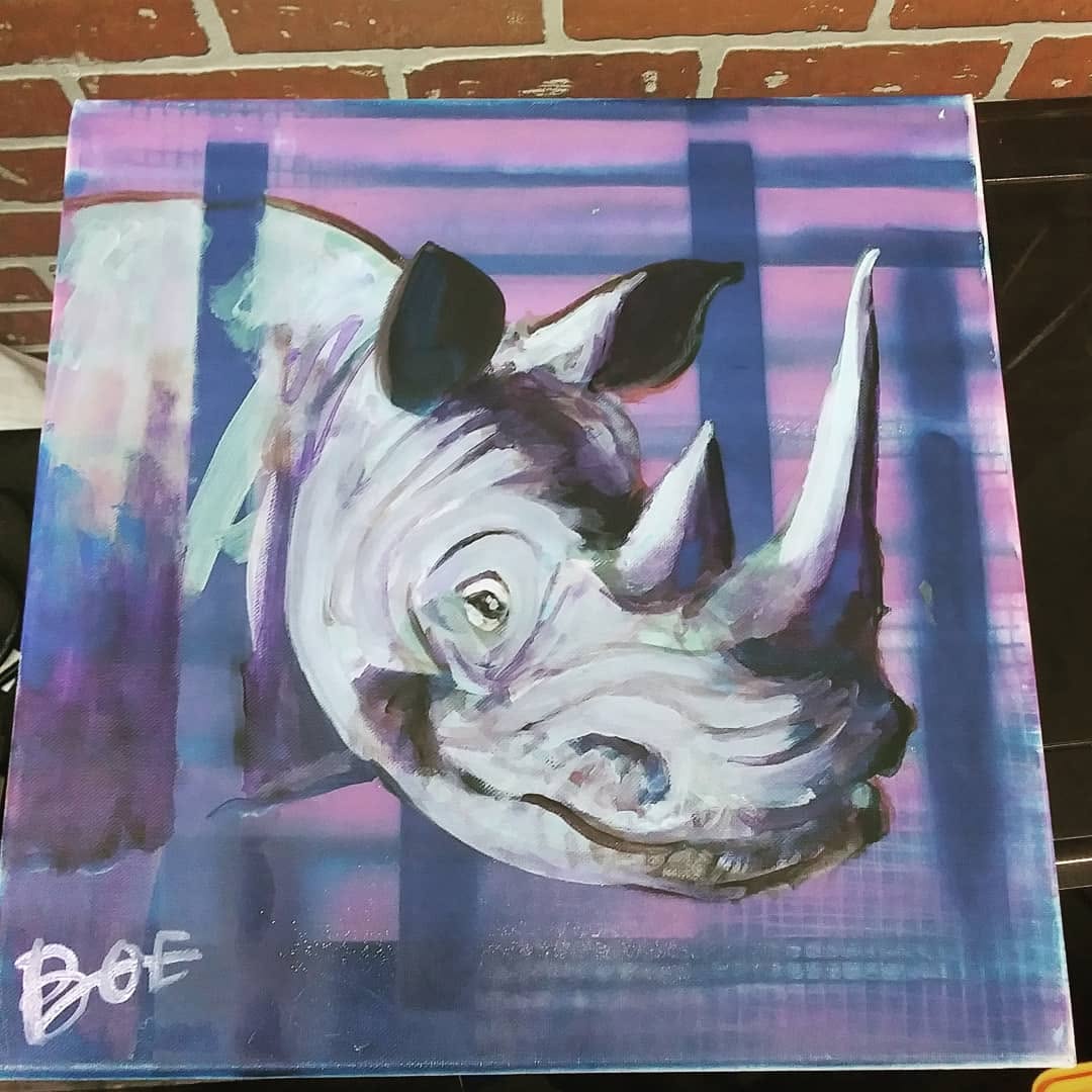 Painted rhinoceros head in lavender, blue and white